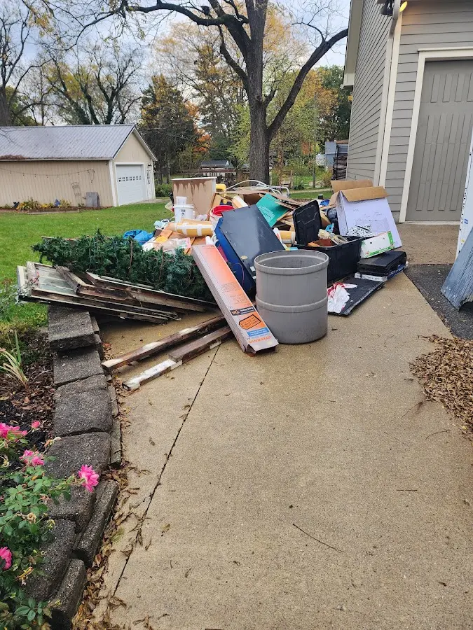 Dumpster being loaded with debris for Demolition Dumpster Rental in Alva